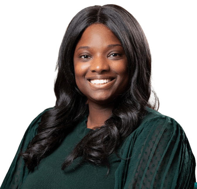 Felicia Ward, with long, wavy black hair and a warm smile, wears a dark green top while posing against a plain white background.