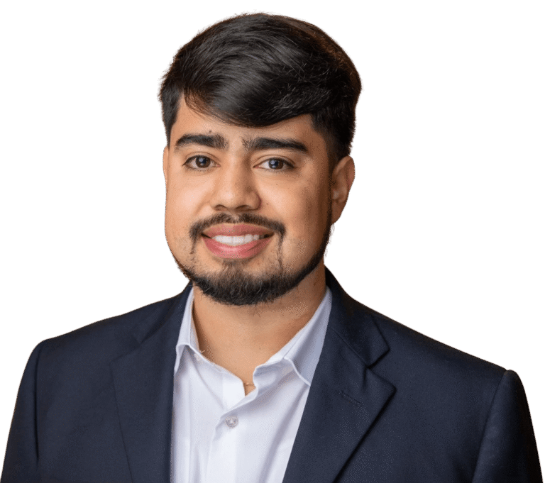Luis Fregoso, a man with dark hair and a beard, wearing a dark suit jacket and white shirt, smiles at the camera against a plain white background.
